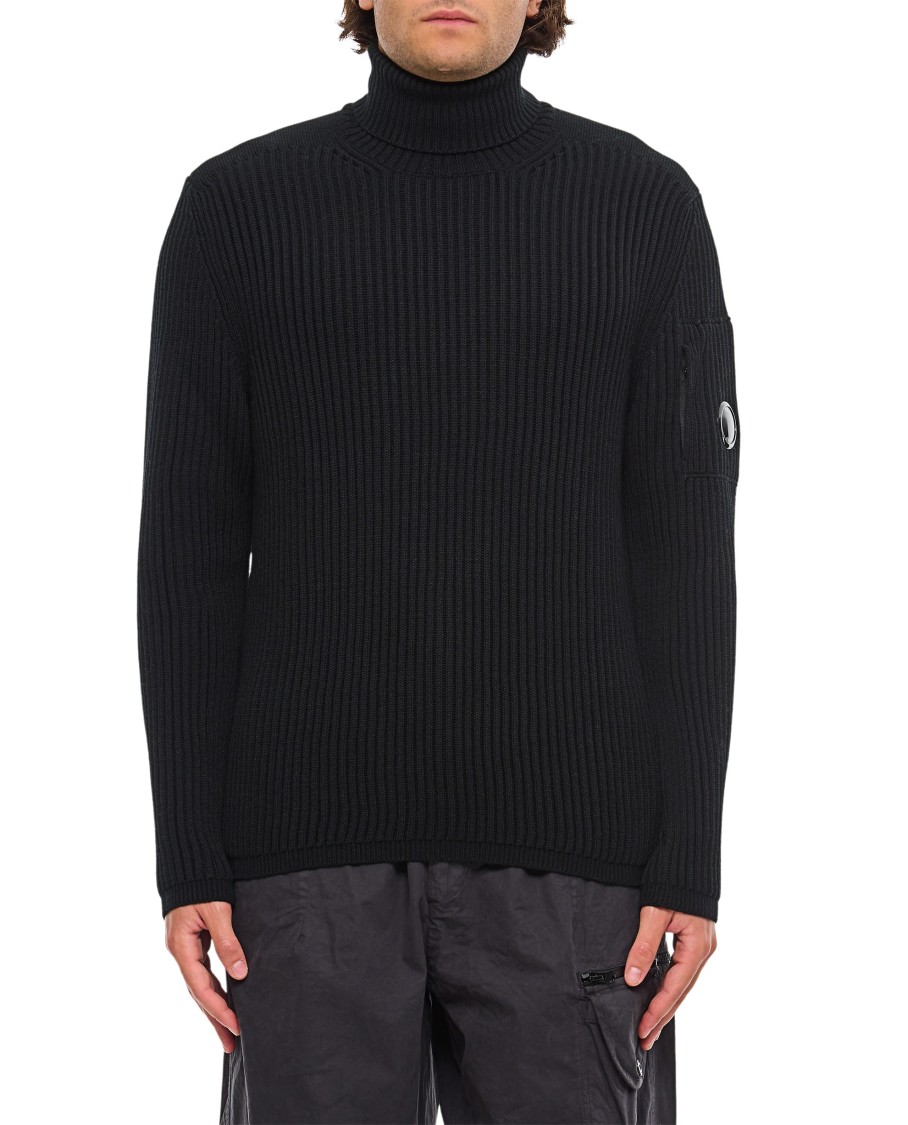 C.p. Company Ribbed Knit Roll Neck Sweater With Signature Lens Detail And Zip Pocket In Black