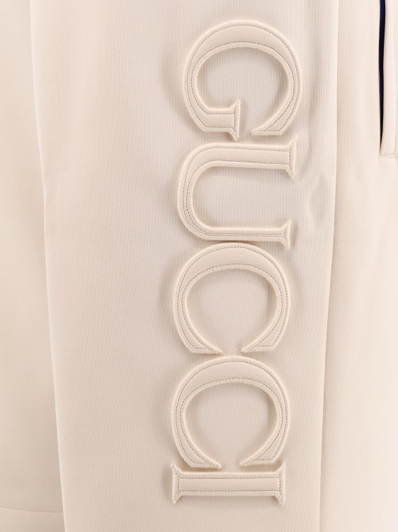 Shop Gucci Embossed Logo Jersey Bermuda Shorts In Neutrals