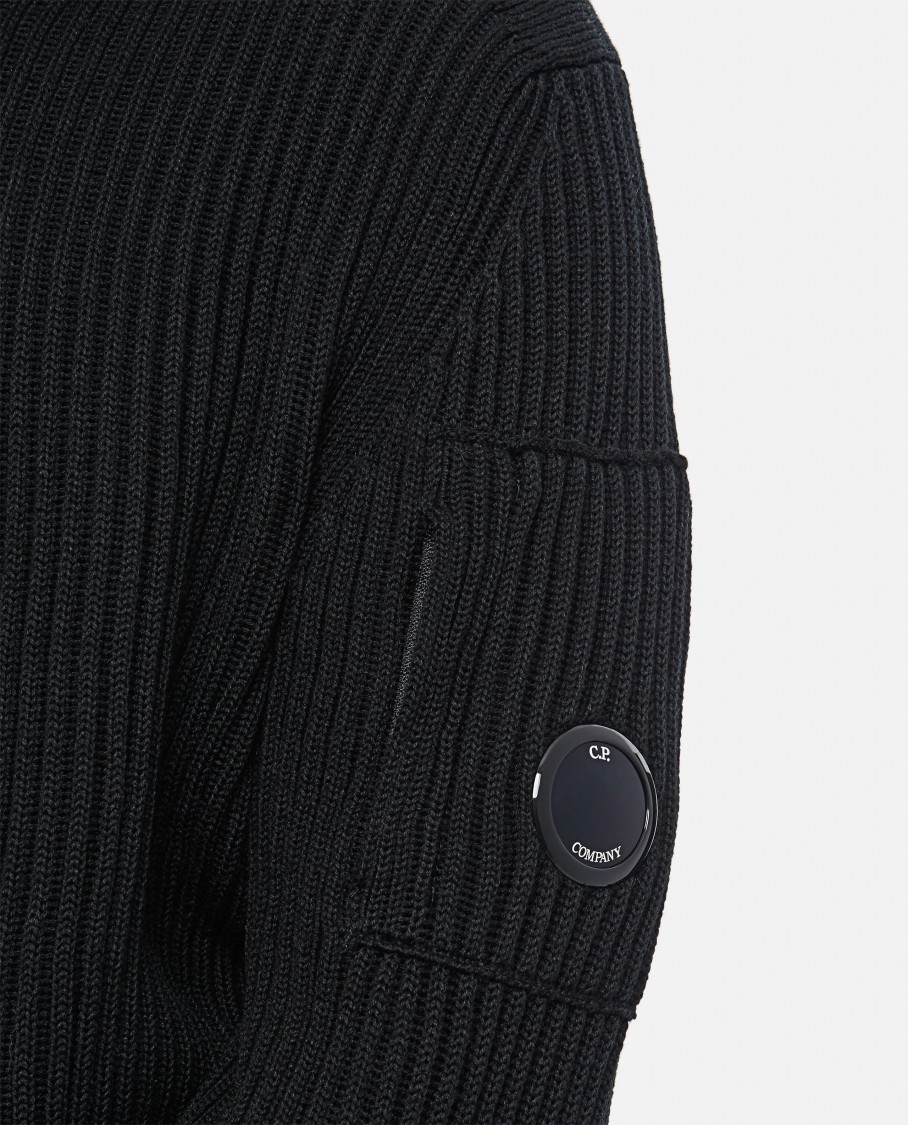 C.p. Company Ribbed Knit Roll Neck Sweater With Signature Lens Detail And Zip Pocket In Black